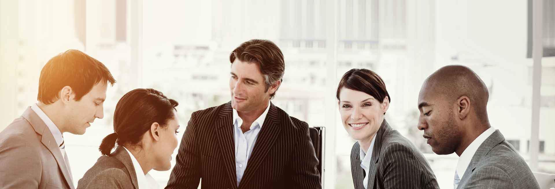 Five literary agents of different ethnicities in business attire sitting in a meeting