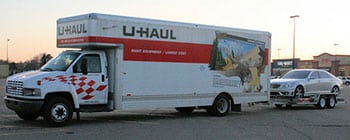 Big U-Haul truck with car on trailer